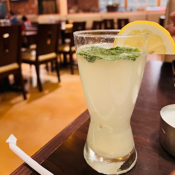 Refreshing lemonade with mint and a lemon slice, served at Garnish Restaurants.