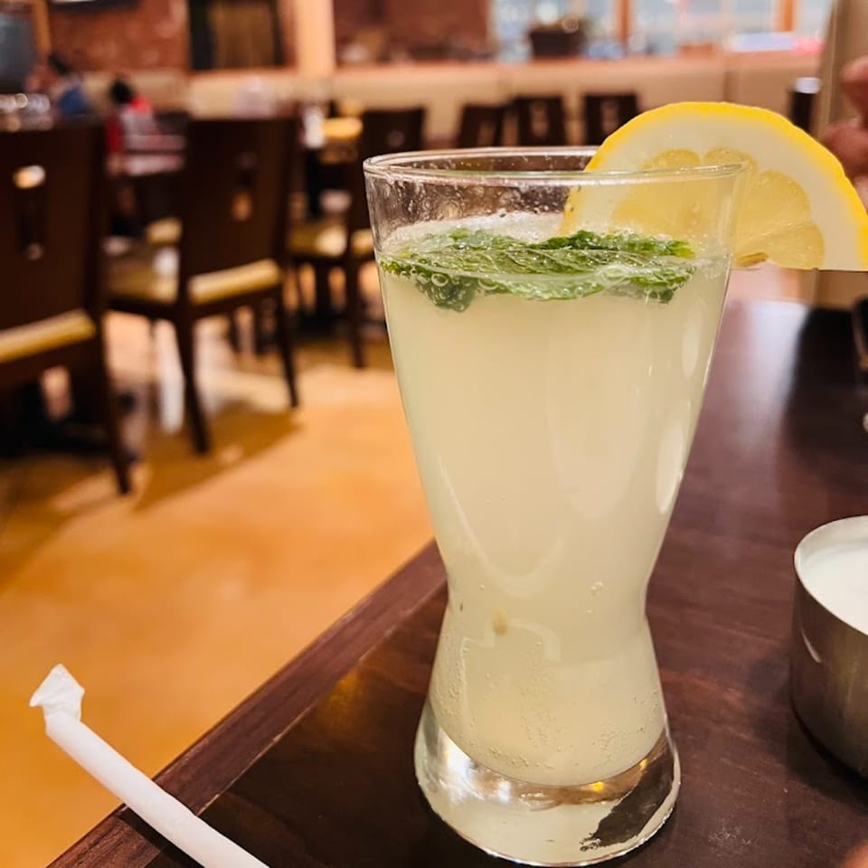 Refreshing lemonade with mint and a lemon slice, served at Garnish Restaurants.
